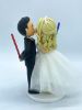 Picture of Tiny Bride & Tall Groom wedding cake topper, Bride is on Ladder kissing groom, Lightsaber Wedding Cake Topper